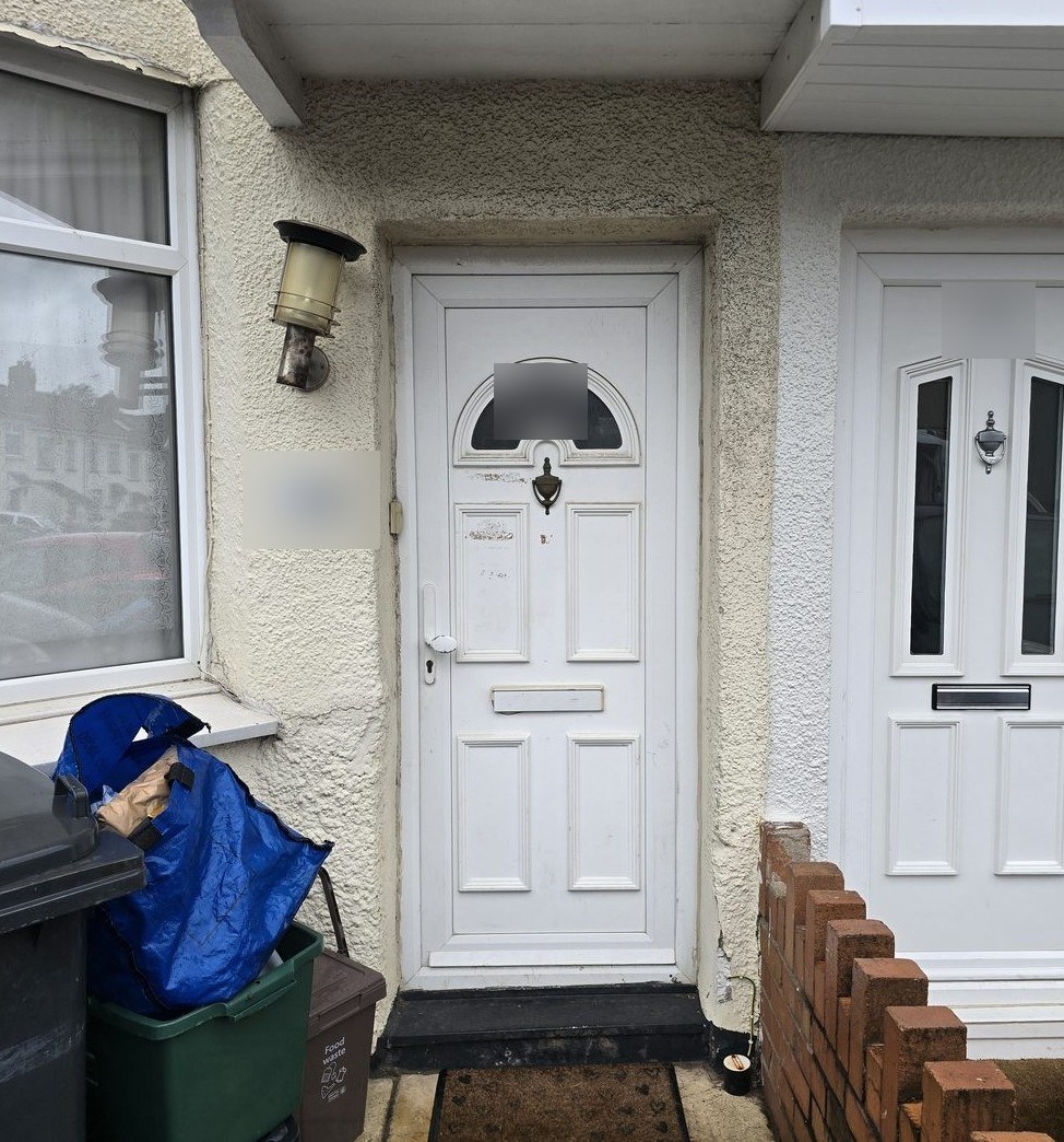 Old white uPVC front door at a house in Brislington, before